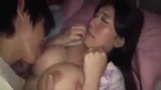 Japanese mother with big round tits wakes up and finds her son playing with her tits and wants to fuck